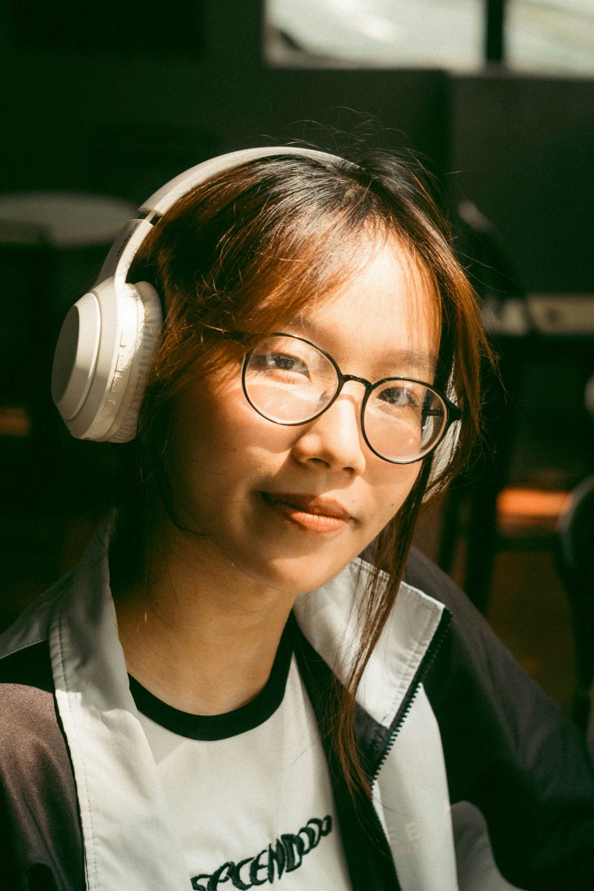 Woman listening to music outdoors, symbolising kind self-talk and inner compassion